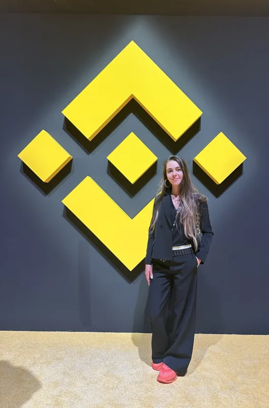 Attendee beside the Binance symbol