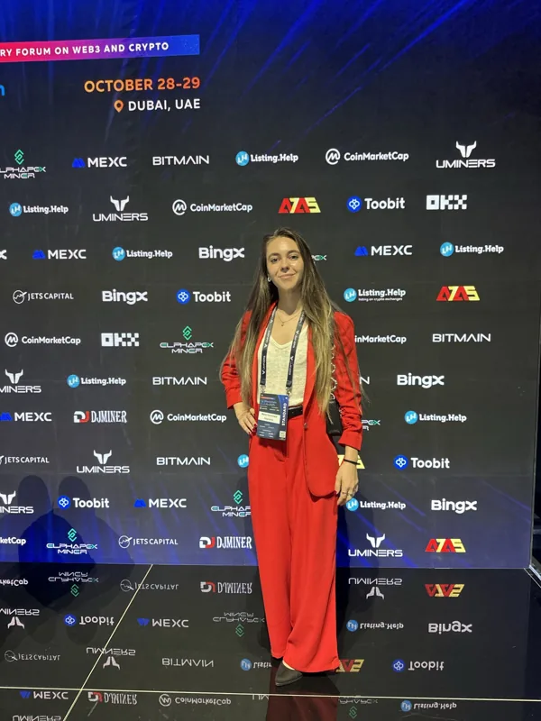 Attendee in front of the Blockchain Life event backdrop